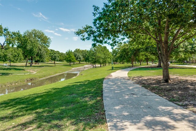 13554 Pyramid Dr, Farmers Branch, TX 75234 - surrounding community featuring a lawn, a water view, and view of scattered trees