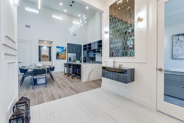 13554 Pyramid Dr, Farmers Branch, TX 75234 - interior space with a high ceiling, baseboards, vanity, and wood finished floors