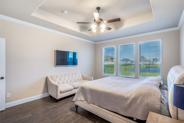 208 Johnson St, Granbury, TX 76048 - bedroom featuring a tray ceiling, baseboards, dark wood-type flooring, a ceiling fan, and ornamental molding