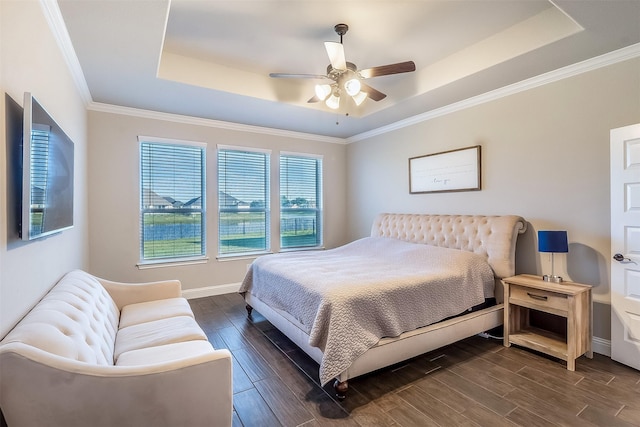 208 Johnson St, Granbury, TX 76048 - bedroom featuring a raised ceiling, dark wood-type flooring, baseboards, ceiling fan, and crown molding