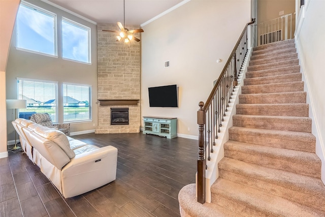 208 Johnson St, Granbury, TX 76048 - living room featuring a high ceiling, baseboards, stairway, ceiling fan, and crown molding