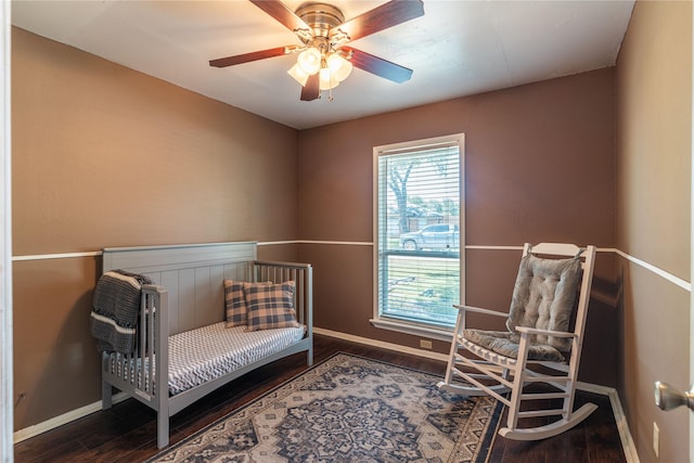 living area featuring baseboards, wood finished floors, and ceiling fan