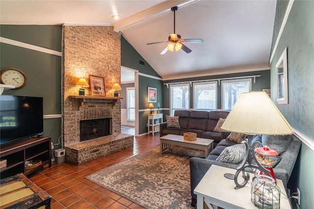 tiled living area with ceiling fan, beam ceiling, a brick fireplace, and high vaulted ceiling
