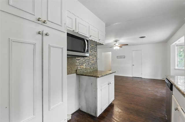 6716 Alma St, Forest Hill, TX 76140 - kitchen with appliances with stainless steel finishes, white cabinets, a ceiling fan, dark stone counters, and dark wood finished floors