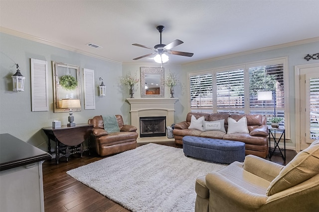 8306 Pecan Creek Dr, Arlington, TX 76001 - living room featuring ceiling fan, crown molding, dark wood finished floors, and a fireplace with raised hearth