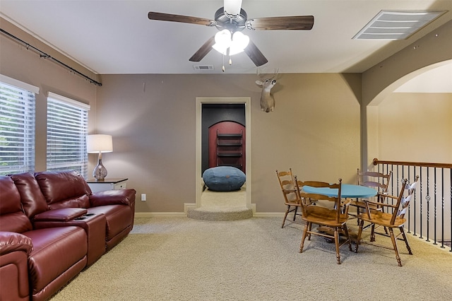 8306 Pecan Creek Dr, Arlington, TX 76001 - carpeted living room featuring ceiling fan, arched walkways, and baseboards