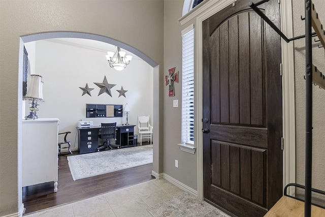 8306 Pecan Creek Dr, Arlington, TX 76001 - tiled foyer entrance with arched walkways, a chandelier, and baseboards