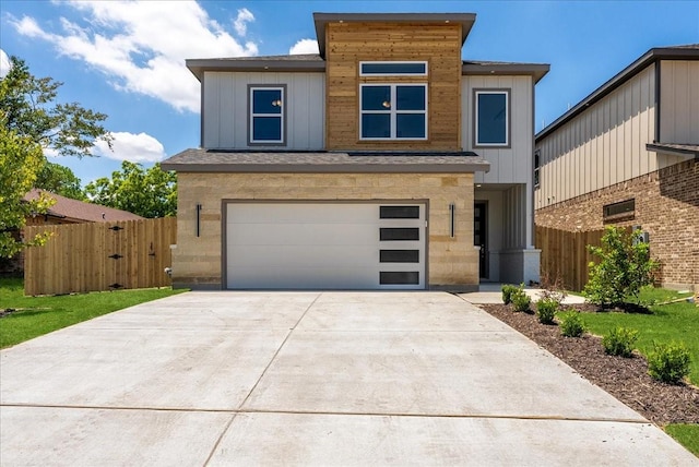 1903 Varsity Dr, Grand Prairie, TX 75051 - view of front facade featuring fence, an attached garage, concrete driveway, and stone siding