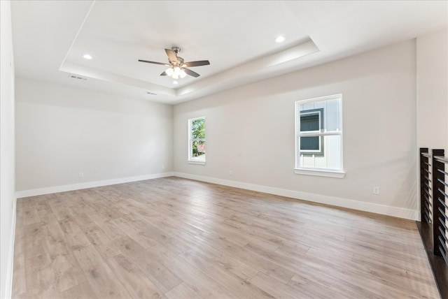 1903 Varsity Dr, Grand Prairie, TX 75051 - unfurnished room with a tray ceiling, light wood-style flooring, ceiling fan, baseboards, and recessed lighting