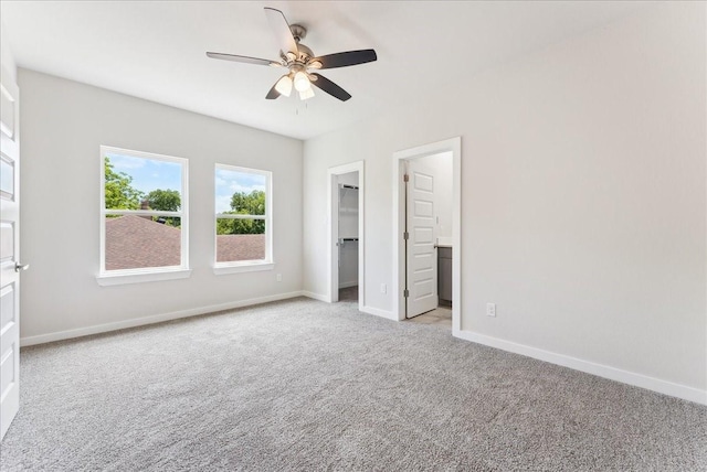 1903 Varsity Dr, Grand Prairie, TX 75051 - unfurnished bedroom with carpet flooring, a walk in closet, baseboards, and ceiling fan