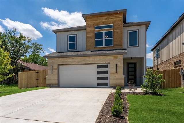 1903 Varsity Dr, Grand Prairie, TX 75051 - contemporary house featuring an attached garage, driveway, and stone siding
