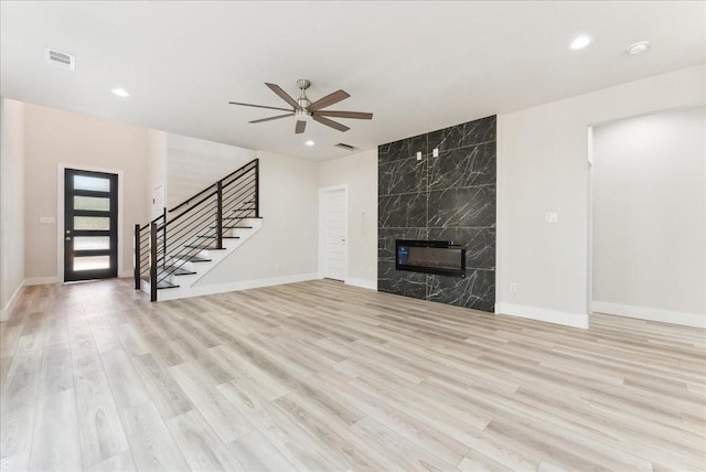 1903 Varsity Dr, Grand Prairie, TX 75051 - unfurnished living room with stairs, a ceiling fan, light wood finished floors, baseboards, and recessed lighting