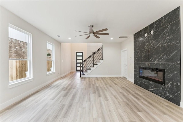 1903 Varsity Dr, Grand Prairie, TX 75051 - unfurnished living room with stairs, light wood-style floors, a fireplace, recessed lighting, and ceiling fan
