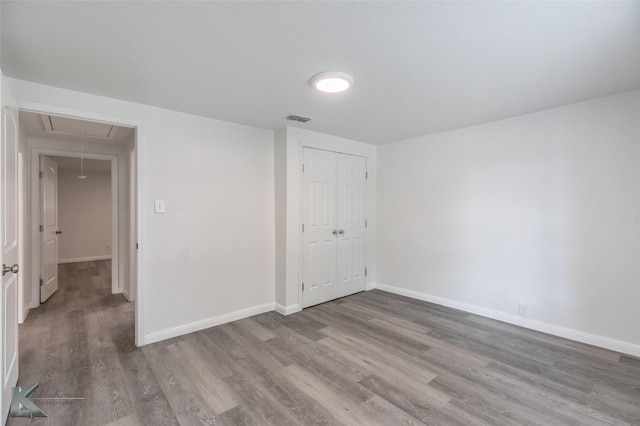 2942 Russell Ave, Abilene, TX 79605 - spare room featuring attic access, wood finished floors, and baseboards