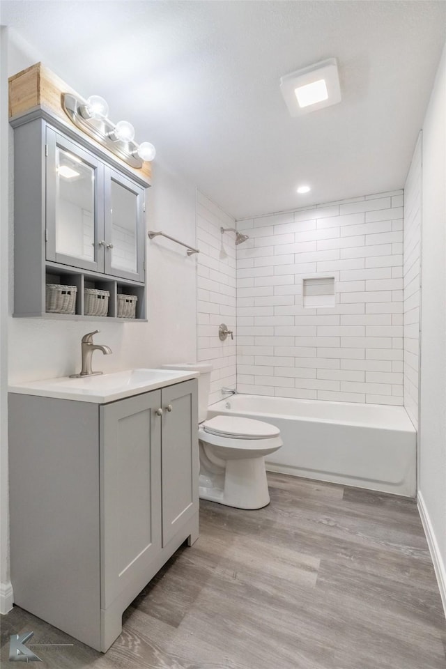 2942 Russell Ave, Abilene, TX 79605 - bathroom featuring vanity, toilet, wood finished floors, and shower / tub combination