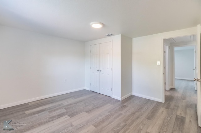 2942 Russell Ave, Abilene, TX 79605 - unfurnished bedroom with attic access, wood finished floors, baseboards, and a closet