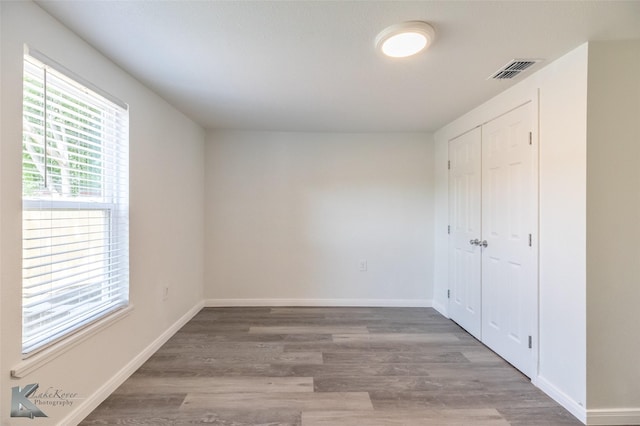 2942 Russell Ave, Abilene, TX 79605 - unfurnished bedroom featuring wood finished floors, a closet, and baseboards