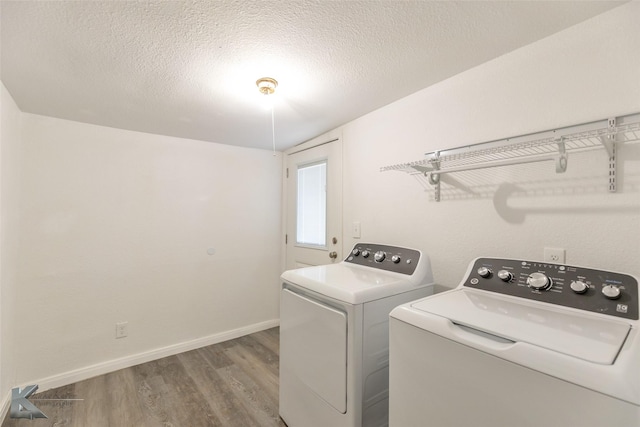2942 Russell Ave, Abilene, TX 79605 - washroom featuring separate washer and dryer, wood finished floors, baseboards, and a textured ceiling