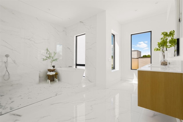 610 N Oak Cliff Blvd Unit 301, Dallas, TX 75208 - full bathroom featuring marble tiled floors, a freestanding tub, and vanity