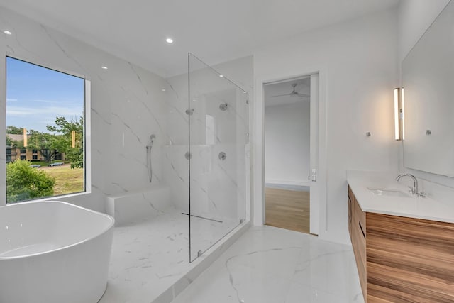 610 N Oak Cliff Blvd Unit 301, Dallas, TX 75208 - bathroom featuring a marble finish shower, vanity, marble tiled floors, a freestanding tub, and recessed lighting