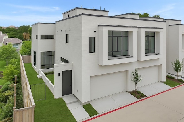 610 N Oak Cliff Blvd Unit 301, Dallas, TX 75208 - modern home featuring stucco siding, a garage, and driveway