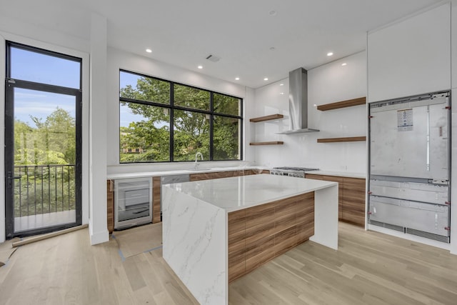 610 N Oak Cliff Blvd Unit 301, Dallas, TX 75208 - kitchen featuring modern cabinets, wall chimney exhaust hood, wine cooler, open shelves, and a center island