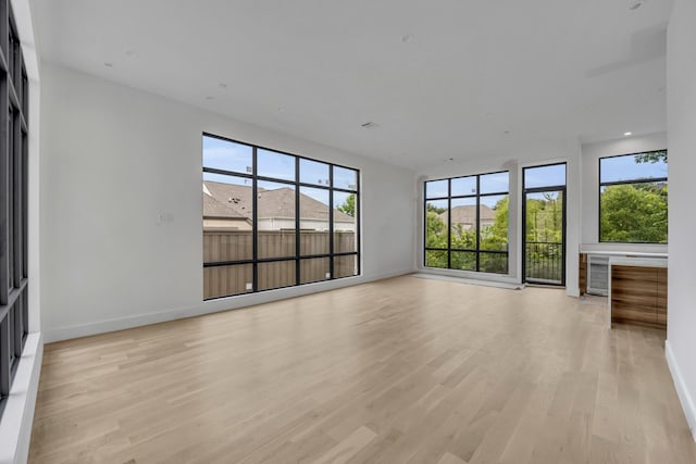 610 N Oak Cliff Blvd Unit 301, Dallas, TX 75208 - unfurnished living room with light wood-style flooring and baseboards