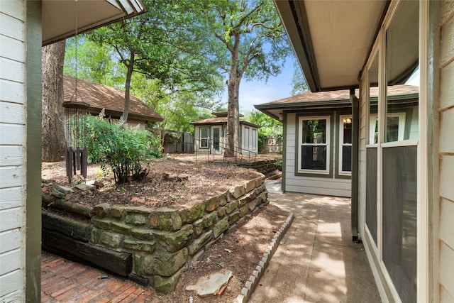 view of patio with fence and an outdoor structure
