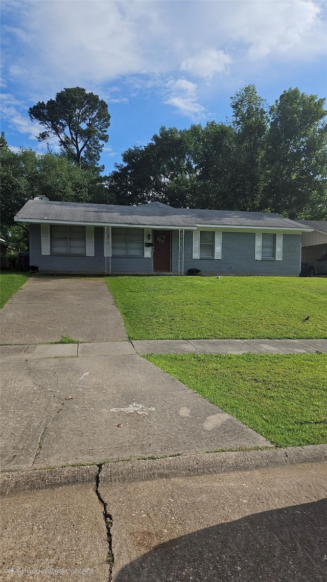 ranch-style house with driveway and a front lawn