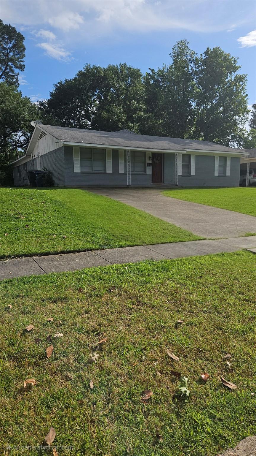 ranch-style home featuring driveway and a front yard
