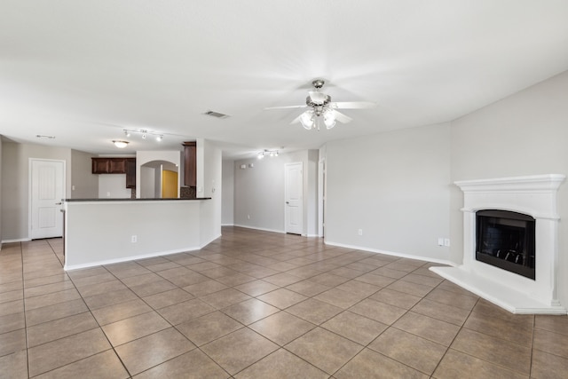 4006 Autumnwood Ln, Heartland, TX 75126 - unfurnished living room with ceiling fan, light tile patterned flooring, a fireplace with raised hearth, and baseboards