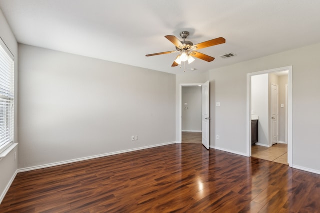 4006 Autumnwood Ln, Heartland, TX 75126 - unfurnished bedroom with wood finished floors, baseboards, a ceiling fan, and ensuite bath