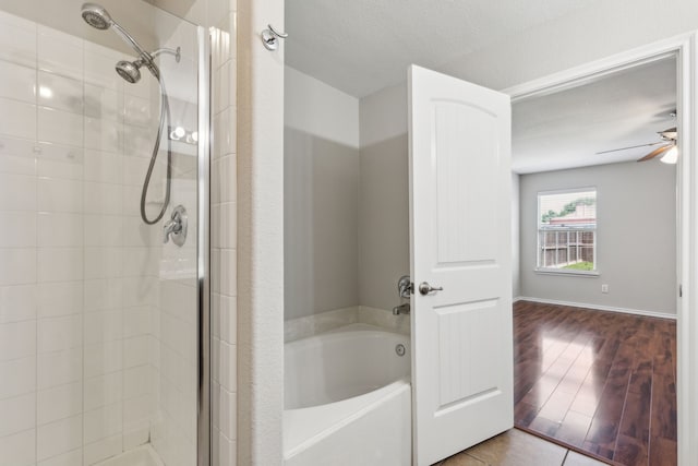 4006 Autumnwood Ln, Heartland, TX 75126 - bathroom featuring a stall shower, a garden tub, a ceiling fan, and wood finished floors