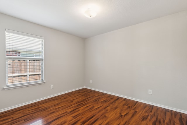 4006 Autumnwood Ln, Heartland, TX 75126 - empty room with dark wood-type flooring and baseboards