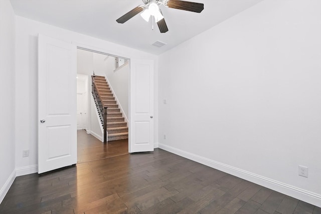 9808 Denali Dr, Little Elm, TX 75068 - empty room with dark wood-style flooring, ceiling fan, and stairway