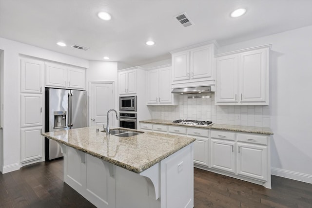 9808 Denali Dr, Little Elm, TX 75068 - kitchen featuring stainless steel appliances, dark wood-style floors, backsplash, a center island with sink, and recessed lighting