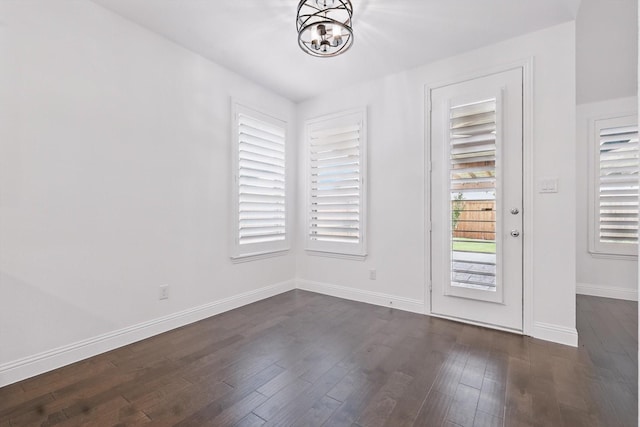 9808 Denali Dr, Little Elm, TX 75068 - unfurnished dining area with a chandelier and dark wood-style flooring