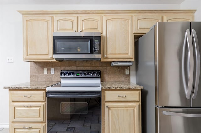 709 Billups Cir, Van Alstyne, TX 75495 - kitchen featuring appliances with stainless steel finishes, light brown cabinets, tasteful backsplash, and stone finish flooring