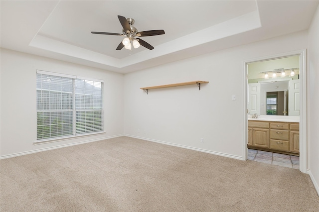 709 Billups Cir, Van Alstyne, TX 75495 - empty room with a raised ceiling, light colored carpet, a ceiling fan, a sink, and baseboards