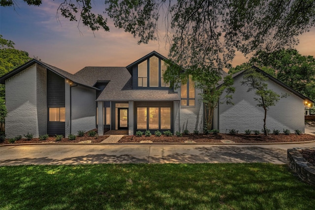 2109 Greta Ln, Fort Worth, TX 76120 - view of front of house with a front lawn, a shingled roof, and brick siding