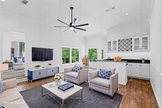 2109 Greta Ln, Fort Worth, TX 76120 - living room with wood finished floors, a high ceiling, crown molding, a ceiling fan, and recessed lighting