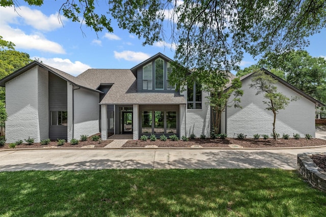2109 Greta Ln, Fort Worth, TX 76120 - view of front facade with brick siding, a shingled roof, and a front lawn