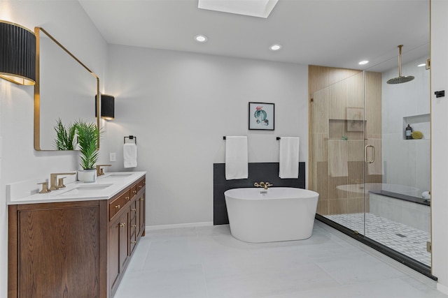2109 Greta Ln, Fort Worth, TX 76120 - full bath featuring a shower stall, double vanity, a soaking tub, recessed lighting, and baseboards