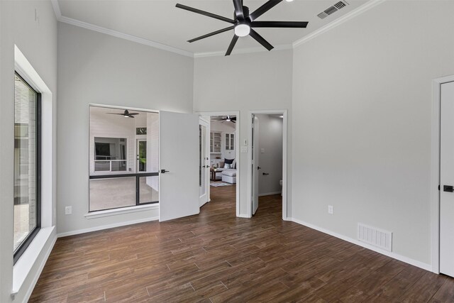 2109 Greta Ln, Fort Worth, TX 76120 - unfurnished bedroom featuring multiple windows, ornamental molding, wood finished floors, a high ceiling, and baseboards