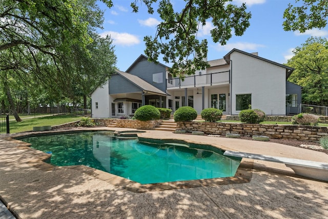 2109 Greta Ln, Fort Worth, TX 76120 - rear view of property with a balcony, fence, a patio, and a pool with connected hot tub