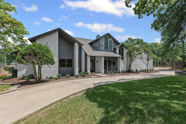 2109 Greta Ln, Fort Worth, TX 76120 - view of front of home with brick siding, a chimney, and roof with shingles