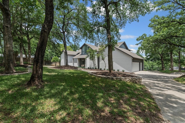 2109 Greta Ln, Fort Worth, TX 76120 - view of front of home with an attached garage, concrete driveway, and a chimney