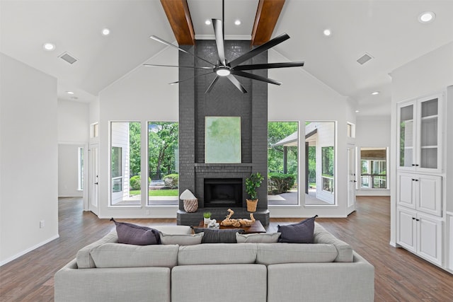 2109 Greta Ln, Fort Worth, TX 76120 - living room with high vaulted ceiling, a fireplace, beamed ceiling, a ceiling fan, and wood finished floors