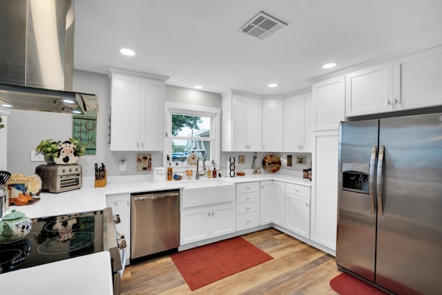 6199 State Highway 22, Hillsboro, TX 76645 - kitchen with stainless steel appliances, a sink, range hood, white cabinets, and recessed lighting