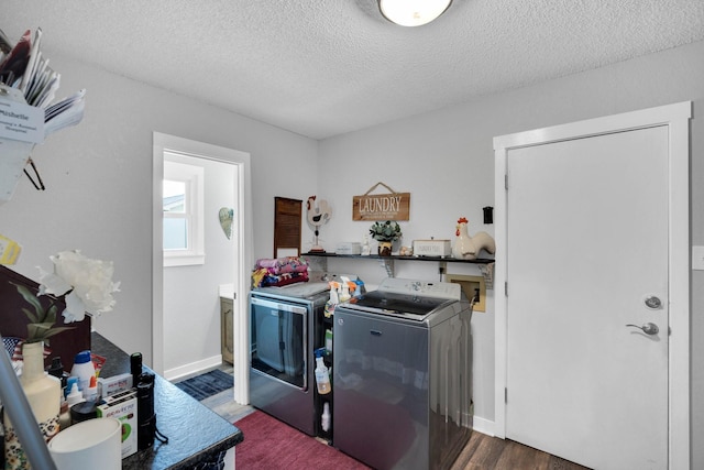 6199 State Highway 22, Hillsboro, TX 76645 - laundry area featuring washing machine and clothes dryer, wood finished floors, a textured ceiling, and baseboards